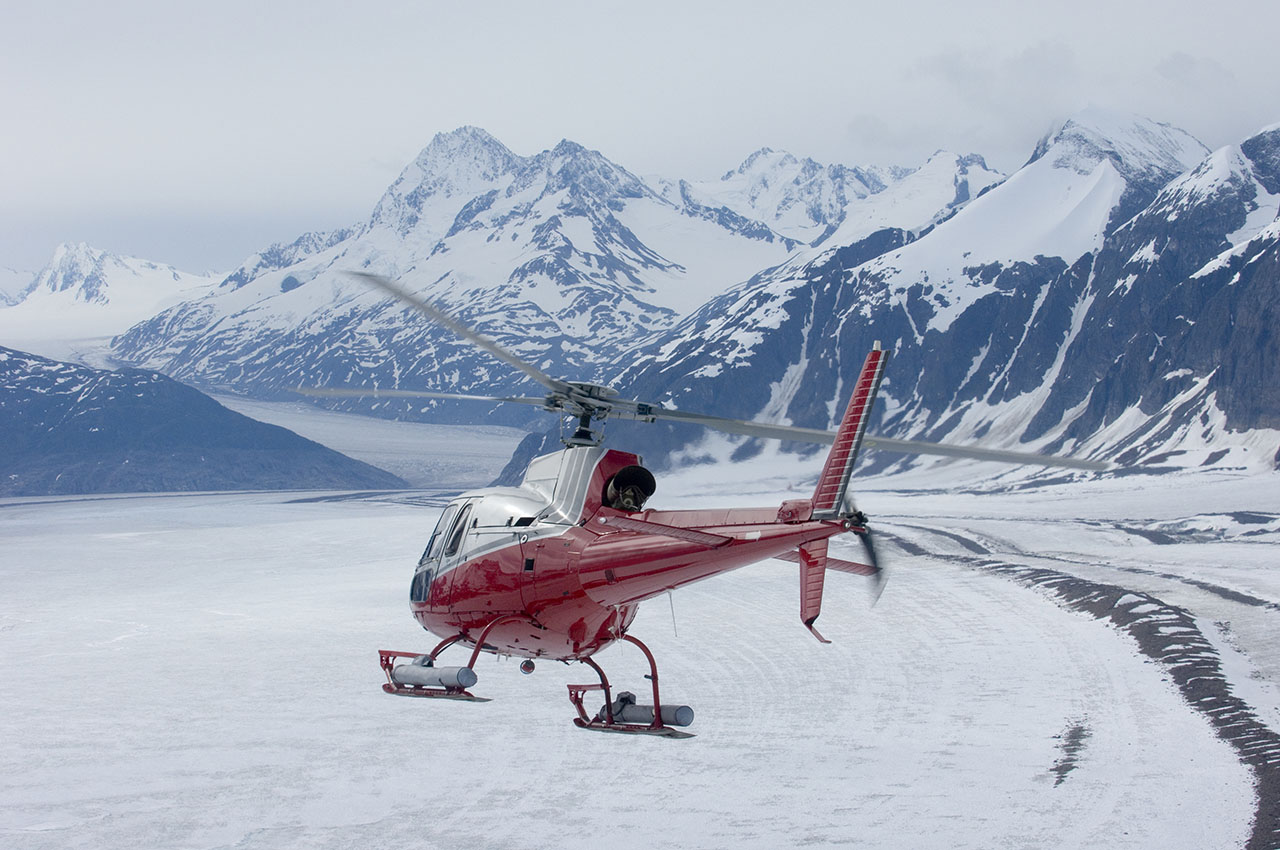 Helicopter flying in Alaska mountains.