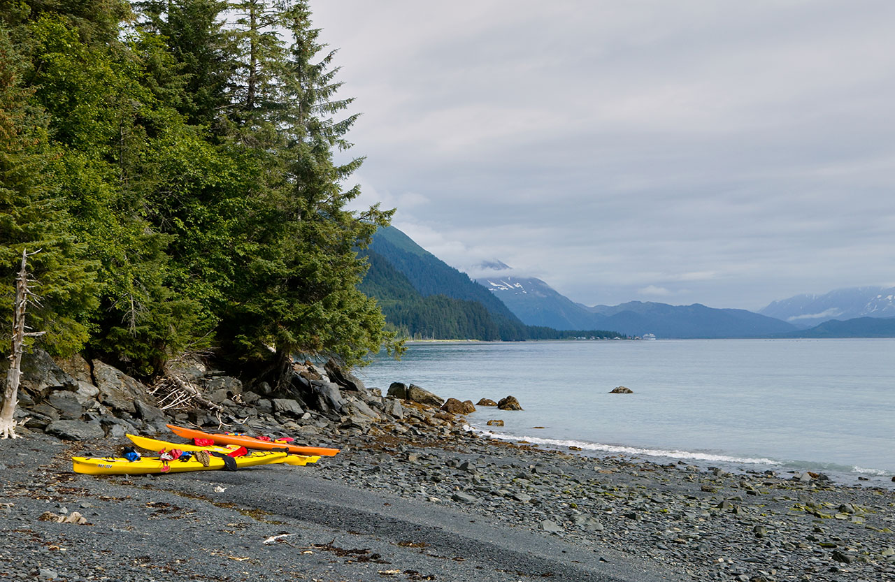 Kayaks on Alaskan sea shore.