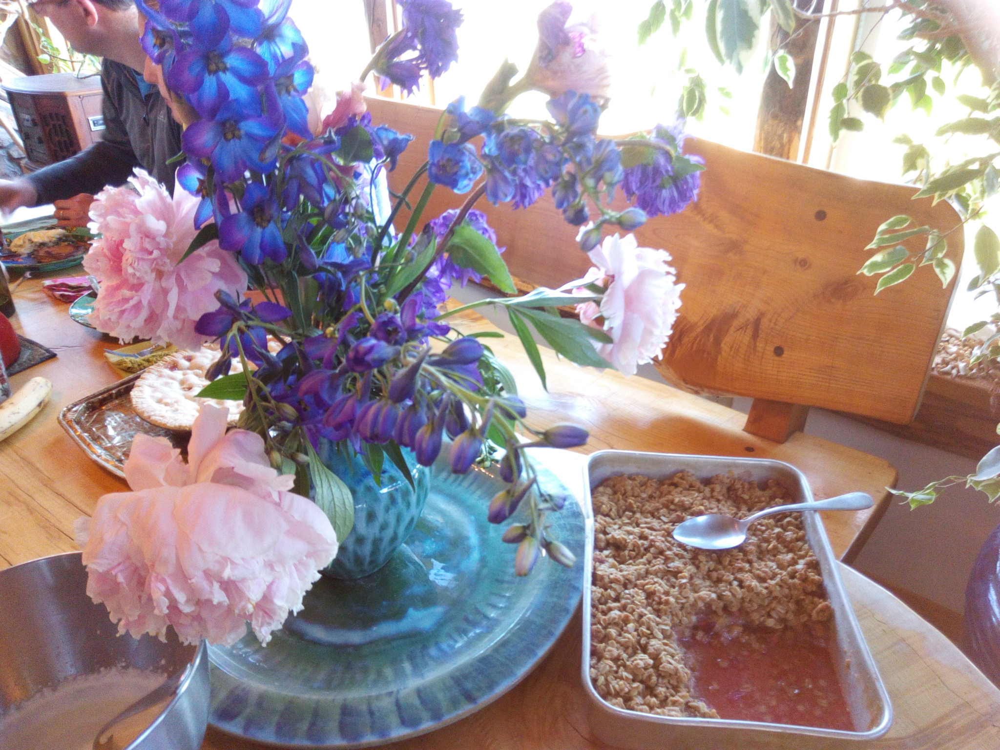 Close up of table flowers and food.